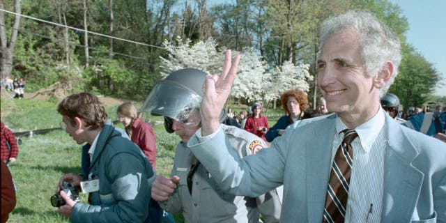 Daniel Ellsberg flashing peace