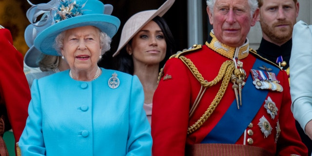 Queen Elizabeth II, King Charles III, Prince Harry, and Meghan Markle stand on the balcony for the Trooping of the Colour 2019