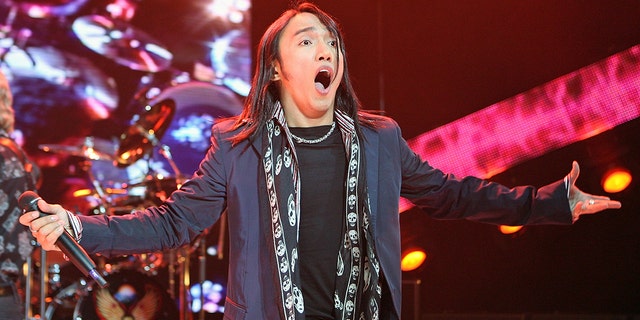 Arnel Pineda performing on stage and looking surprised