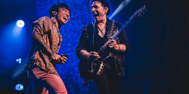 Arnel Pineda and Neal Schon performing on stage