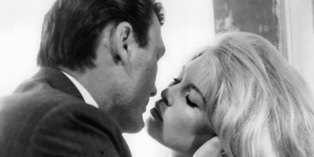 Jack Palance kissing Brigitte Bardot