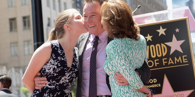 Bryan Cranston on the Hollywood walk of fame being kissed by his wife Robin and their daughter Taylor