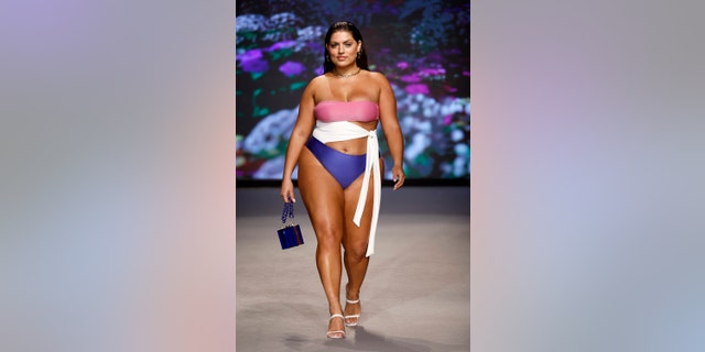 Ella Halikas modeling a pink, white and blue bikini on the runway