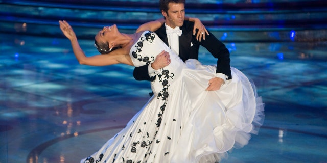 Emanuele Filiberto in a tuxedo holding a woman wearing a white ball gown