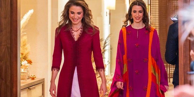Queen Rania and her daughter-in-law Princess Rajwa wearing burgundy gowns at a henna party