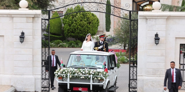 Jordans Crown Prince Hussein (R) and his wife Saudi Rajwa al-Seif in their car