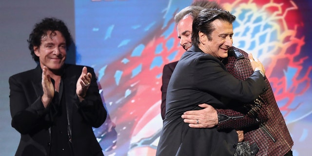 Steve Perry embracing Jonathan Cain at the Rock and Roll Hall of Fame