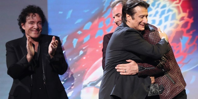 Steve Perry embracing Jonathan Cain at the Rock and Roll Hall of Fame