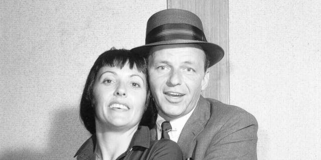 Keely Smith being embraced by Frank Sinatra in a black and white photo
