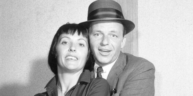 Keely Smith being embraced by Frank Sinatra in a black and white photo