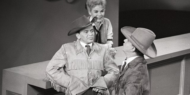 Frank Sinatra and Louis Prima filming a skit in cowboy gear