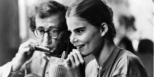 Mariel Hemingway drinking a milkshake next to Woody Allen