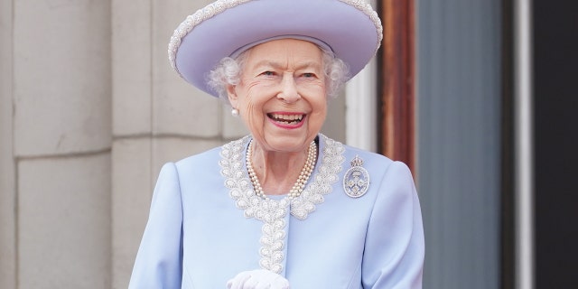 Queen Elizabeth wearing a powder blue dress and pearls