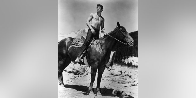 Rock Hudson shirtless on a horse