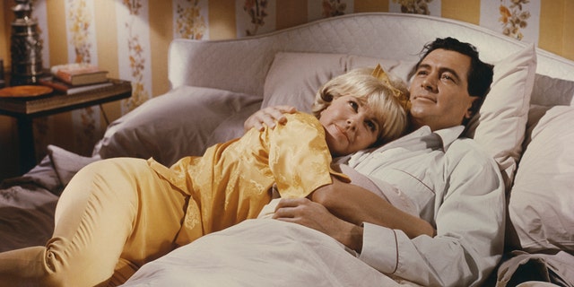 Doris Day and Rock Hudson embracing in bed