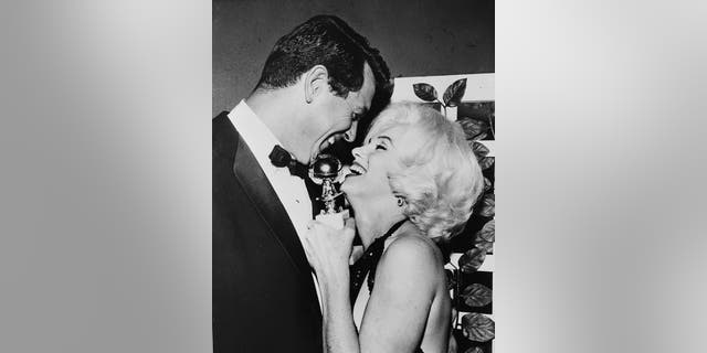 Rock Hudson and Marilyn Monroe sharing a sweet embrace at the Golden Globes