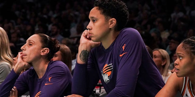 Brittney Griner with Diana Taurasi sit on bench