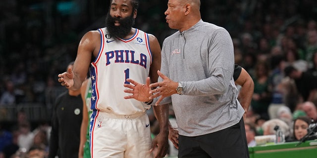James Harden talks to Doc Rivers during a game