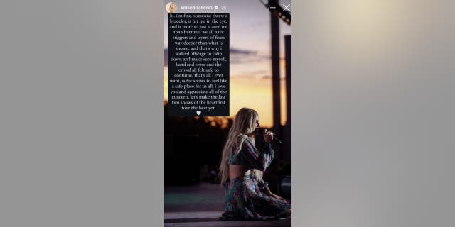 Kelsea Ballerini kneels on stage in an Instagram story where she updates fans on her well-being after being hit with a bracelet in the eye