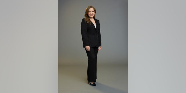 Sarah Rose poses in a black suit