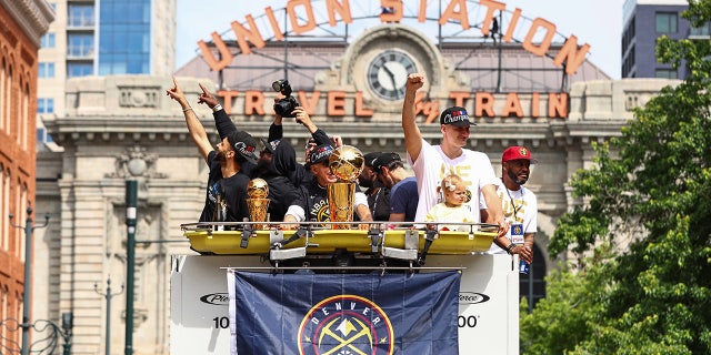 Jamal Murray and Nikola Jokic celebrate at the championship parade