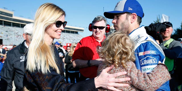 Jimmie Johnson and his family at a NASCAR race