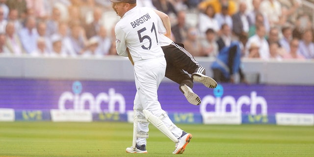 Johnny Bairstow carries a protester