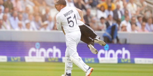 Johnny Bairstow carries a protester