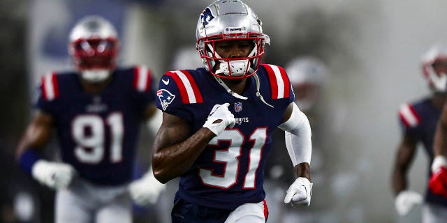 Jonathan Jones runs on to the field before an NFL game in 2022