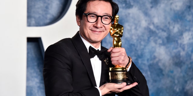 Ke Huy Quan poses with his Oscar
