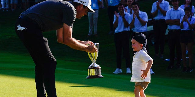 Keegan Bradley celebrates with his son