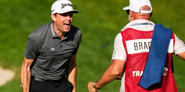 Keegan Bradley celebrates with caddy
