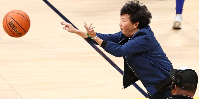 Ken Jeong next to the court