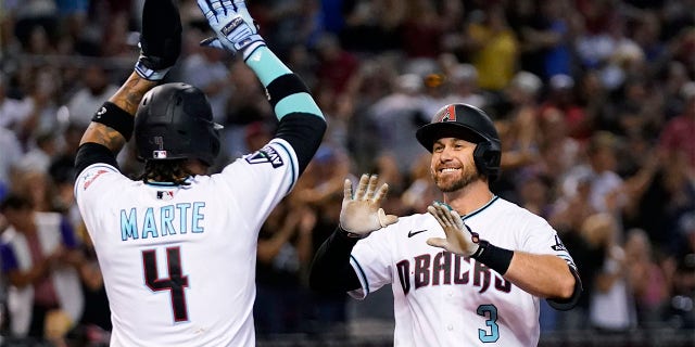 Evan Longoria celebrates with Ketel Marte