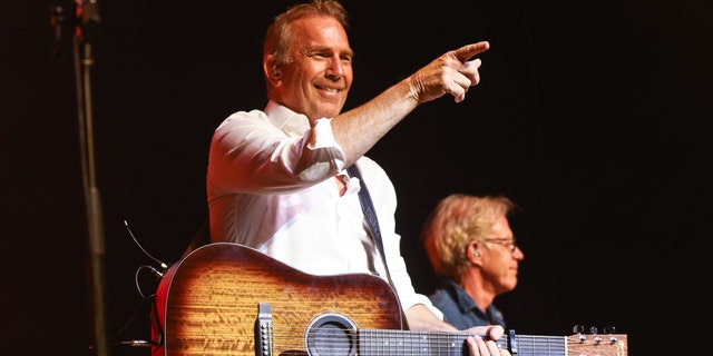 Kevin Costner on stage with his band Modern West