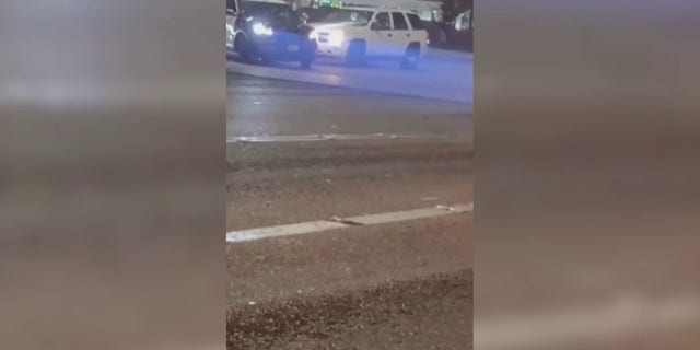 The sheriff's deputy fires at the suspected driver of the white SUV