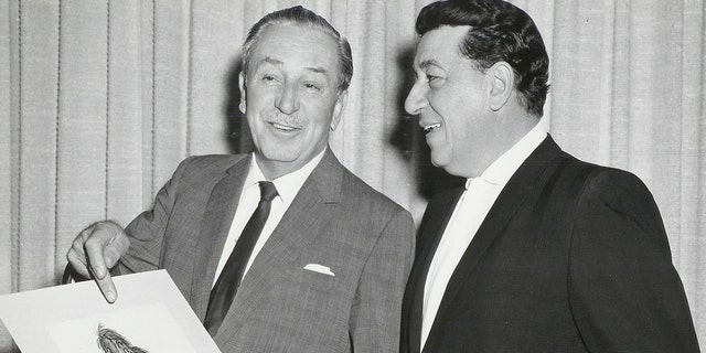 Louis Prime looking a a drawing of King Louie being held by Walt Disney