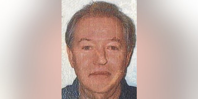 Leslie Arnold smiles slightly in a passport photo.