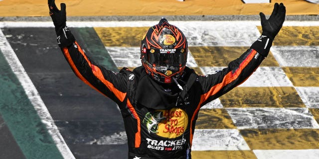 Martin Truex Jr raises his hands