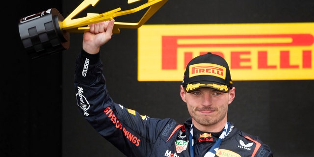 Max Verstappen holds up the trophy