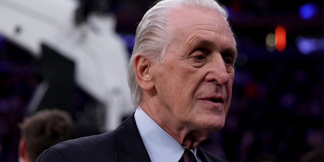 Pat Riley walks by the basketball court