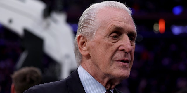 Pat Riley walks by the basketball court