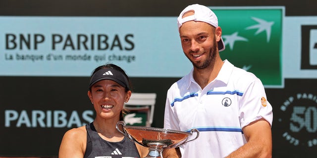 Miyu Kato and Tim Puetz pose with a trophy