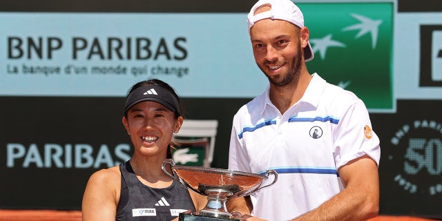 Miyu Kato and Tim Puetz pose with a trophy