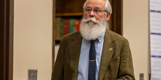 Prosecutor Bill Thompson walks through the courtroom