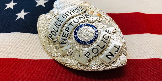 Neptune Township police badge in front of American Flag