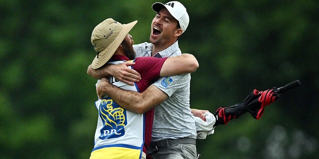 Nick Taylor celebrates with caddy