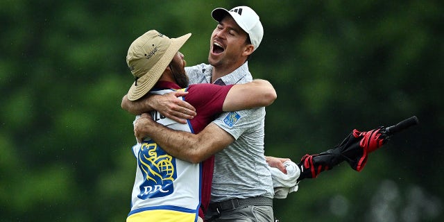 Nick Taylor celebrates with caddie