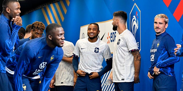 Christopher Nkunku smiles with his teammates