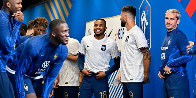 Christopher Nkunku smiles with teammates